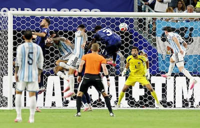 Cristian Romero heads in Argentina's winning goal. Reuters
