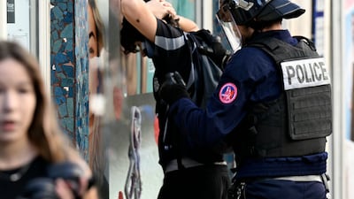 A protester is detained during a demonstration by pupils in Nancy, France. AFP