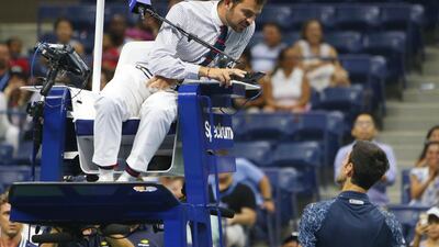 Djokovic talks with the chair umpire after being called for two time violations while serving against Millman. Jerry Lai / USA TODAY Sports