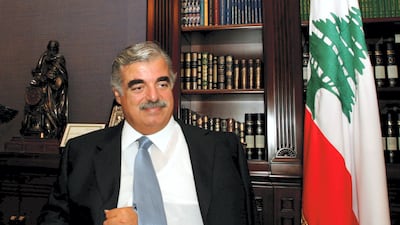 Former Lebanese prime minister Rafik Hariri, his fractured shoulder in a sling, smiles during an interview at his office in Beirut, in September 2004. He was assassinated in 2005. AFP