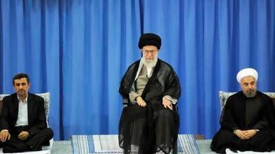 Iran's supreme leader Ayatollah Ali Khamenei, centre, officially endorses Hassan Rowhani, right, as the new country's president in Tehran. Mr Rouhani takes over from Mahmoud Ahmadinejad, left. khamenei.ir / AFP