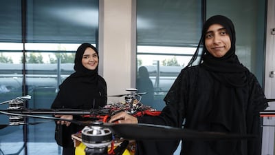 Khalifa University students Alaya AlMaaizmi and Mouza Al Shemaili demonstrate a drone that is designed to dissipate fog. (Photo: Antonie Robertson / The National)