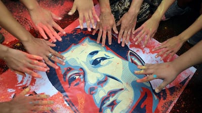 Activists show their hands stained with colored powder next to a portrait of newly elected Philippine President Rodrigo Duterte during a rally outside the presidential palace in metro Manila, Philippines. Ezra Acayan / Reuters