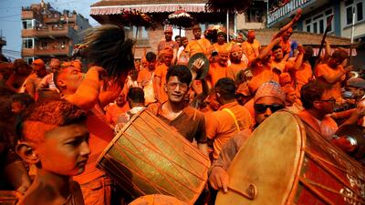 Devotees play traditional musical instruments while celebrating 'Sindoor Jatra' vermillion powder festival at Thimi, in Bhaktapur, Nepal. Reuters