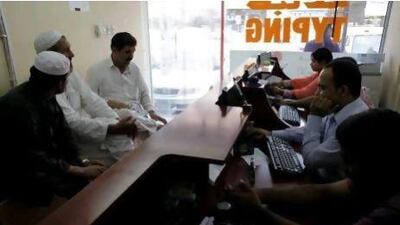 Typist stand by to help customers at the Darwish Typing centre on the last day to resister for a Emirates ID in Dubai June 30, 2012.