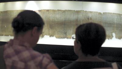 Tourists looks at a replica of the Dead Sea Scrolls on display at the Israel Museum. Getty Images