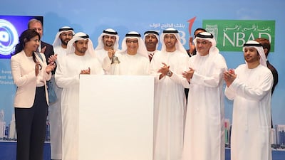 Executives od newly merged First Abu Dhabi Bank ring the bell at the Abu Dhabi Securities Exchange to start the newly merged bank’s first day of trading. Courtesy First Abu Dhabi Bank