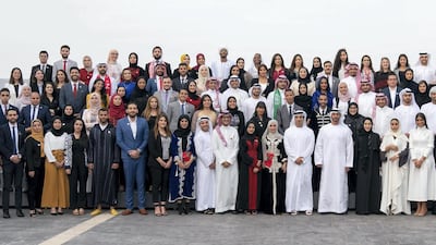 Sheikh Mohamed stands for a group photo with members of the Young Arab Media Leaders Programme, during a Sea Palace barza. Hamad Al Kaabi / Ministry of Presidential Affairs