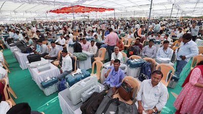 Election staff wait with the Voter Verifiable Paper Audit Trails and Electronic Voting Machines at a distribution centre in Bikaner, Rajasthan, on Thursday. Reuters