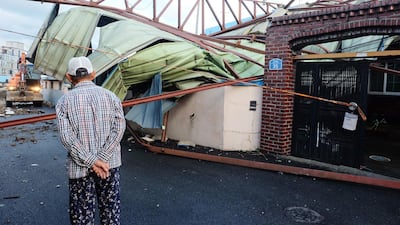 A man looks at a house damaged by Typhoon Maysak in Ulsan. AFP