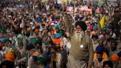 An elderly farmers shouts slogans as others listen to a speaker as they block a major highway during a protest at the Delhi-Haryana state border, India. Talks between protesting farmers and the Indian government failed. AP