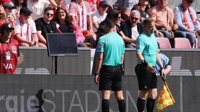 Referee Sven Jablonski checks a VAR screen before disallowing a goal scored by Bayern Munich's Leroy Sane. Reuters