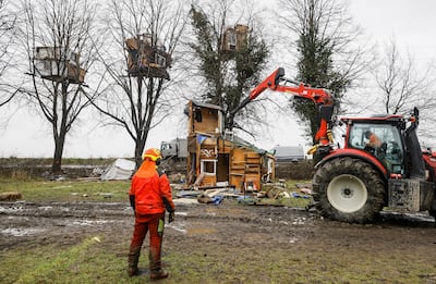 A digger demolishes a wooden house put up by activists in Luetzerath. EPA