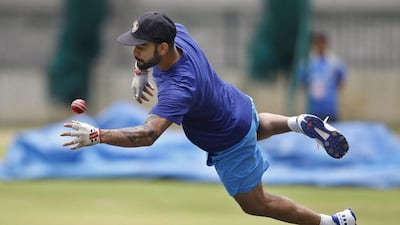 India cricket team captain Virat Kohli dives to catch the ball on the last day of team’s six day training camp at National Cricket Academy in Bangalore, India, Monday, July 4, 2016. Aijaz Rahi / AP Photo