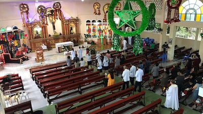 A Christmas Mass is held in a destroyed church in Alegria, in the Philippines, more than a week after Super Typhoon Rai devastated the area. AFP