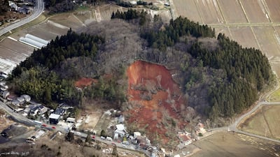A landslide swallows about a dozen homes in Tsuruoka, Yamagata prefecture, north of Tokyo. AP