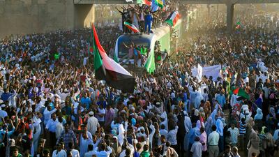 Sudanese protesters cheer after arriving from the capital Khartoum to the town of Atbara to celebrate the anniversary of the uprising that toppled Omar Al Bashir. AFP