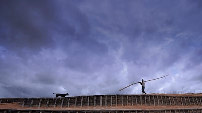 Rohingya man carries a bamboo pole at Kutupalong refugee camp in Ukhia on July 23, 2019. AFP