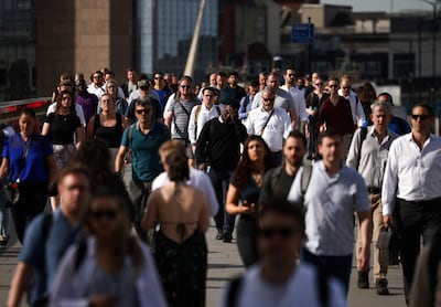 Commuters walk over London Bridge. As the cost of living rises, more workers see savings from working at home. REUTERS / Henry Nicholls