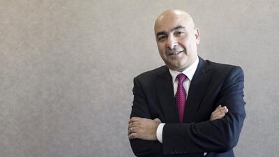 Wael Al Sharif, the chief executive of Takaful Emarat, praises his team members for the insurer’s success. Reem Mohammed / The National