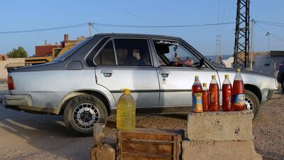 Bottles filled with smuggled oil from Algeria are on display for sale near the Moroccan city of Oujda along the Moroccan-Algerian border. Fadel Senna / AFP