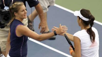 Julie Coin, left, shakes hands with Ana Ivanovic after beating the women's top seed 6-3, 4-6, 6-3 at the US Open.