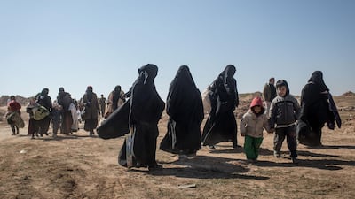 Civilians who have fled fighting in Bagouz wait to board trucks. Getty Images