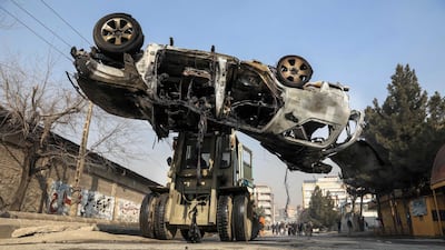 Kabul police officers remove the wreckage of a damaged car in the aftermath of a bomb explosion in Kabul, Afghanistan. At least three people were killed and two others injured after an improvised explosive device (IED) explosion targeted the vehicle of Zia Wadan, an Afghan journalist-turned spokesman for the Public Protection Force in Kabul. EPA