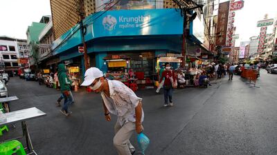A man wearing a protective mask rides his skateboard in Chinatown. Reuters