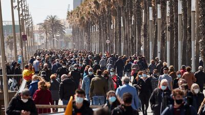 People walk along a promenade in Barcelona, Spain. EPA