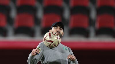 Morocco coach Walid Regragui juggles with a ball. AFP