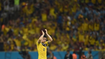 James Rodriguez applauds as he goes off the pitch during Colombia's 2-0 win over Uruguay on Saturday night to advance to the 2014 World Cup quarter-finals. Eitan Abramovich / AFP / June 28, 2014