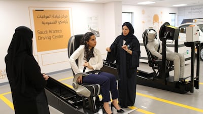 A driving instructor, right, explains the importance of buckling up. Ahmed Jadallah / Reuters