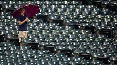 A fan waits out the rain during a delayed start of the game between the Cleveland Indians and the Tampa Bay Rays earlier this season. Tampa Bay has strated to flirt with the idea of moving the club to Montreal. Jason Miller/Getty Images