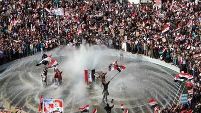 Syrians splash around in a pond at a rally to show support for President Bashar Al assad in Damascus yesterday, a day after the Arab league suspended Syria until Mr Assad implements an Arab deal to end violence against protesters.