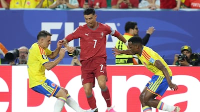 Colombia's defender #04 Santiago Arias, Portugal's forward #07 Cristiano Ronaldo, and Colombia's midfielder #11 Jhon Arias fight for the ball during the 2026 World Cup Group K football match between Colombia and Portugal at the Miami Stadium in Miami Gardens. AFP