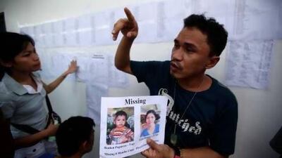 Roderick Mama shows portraits of his missing wife and son who were passengers on the ill-fated MV St Thomas Aquinas.