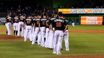 Miami Marlins players shake hands after their win over the New York Mets. The entire team wore Jose Fernandez jerseys. Rob Foldy/Getty Images