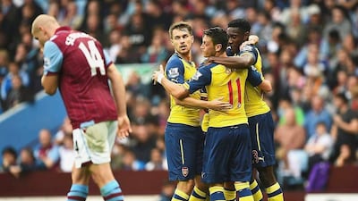 Mesut Ozil (No 11) celebrates with Danny Welbeck, right, as Arsenal surprised Aston Villa against the run of play by finding the net three times in the space of five minutes. Laurence Griffiths / Getty Images