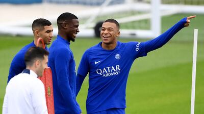 PSG defender Nordi Mukele, centre, shares a laugh with Kylian Mbappe on Tuesday. AFP