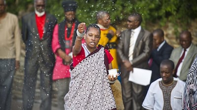 A traditional worshipper sprinkles holy water in prayer at dawn in Freedom Park in Pretoria. AP Photo
