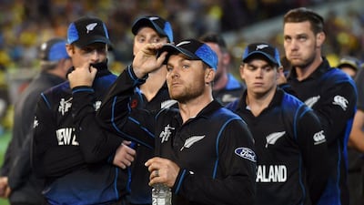 Brendan McCullum, centre, and his New Zealand team look on dejected after losing the cricket World Cup final. William West / AFP