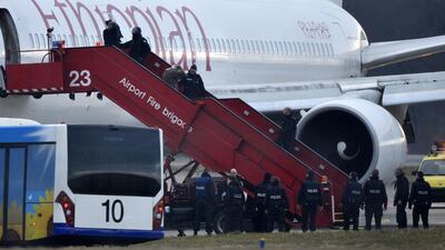 Swiss police evacuate passengers from the Ethiopian Airlines flight ET702 to Rome that was hijacked and rerouted to Geneva. Richard Juilliart / AFP Photo