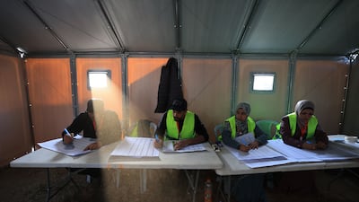 Palestinian electoral workers begin counting votes after the close of polling at a makeshift voting station during municipal elections in Deir Al-Balah, Gaza. AFP