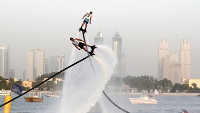 People compete in the flyboard section of the Dubai Watersports Summer Week.