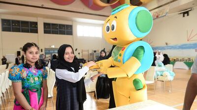 A mascot gives children education material about healthy choices in food and how to avoid diabetes. Photo Courtesy Ogilvy