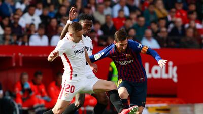 Messi rides a challenge during their game with Sevilla. Reuters