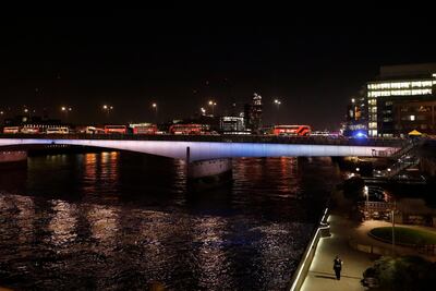 Abandoned buses are parked while police forensic officers work on London Bridge. AP