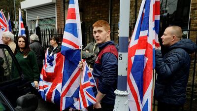 People hold the Union Flag while attending a Britain First rally in Kent as the far-right group's deputy leader Jayda Fransen, left, looks on. Kevin Coombs / Reuters
