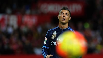 Real Madrid's Portuguese forward Cristiano Ronaldo eyes the ball during the Spanish league football match Sevilla FC vs Real Madrid CF at the Ramon Sanchez Pizjuan stadium in Sevilla on November 8, 2015. AFP PHOTO/ CRISTINA QUICLER / AFP / CRISTINA QUICLER